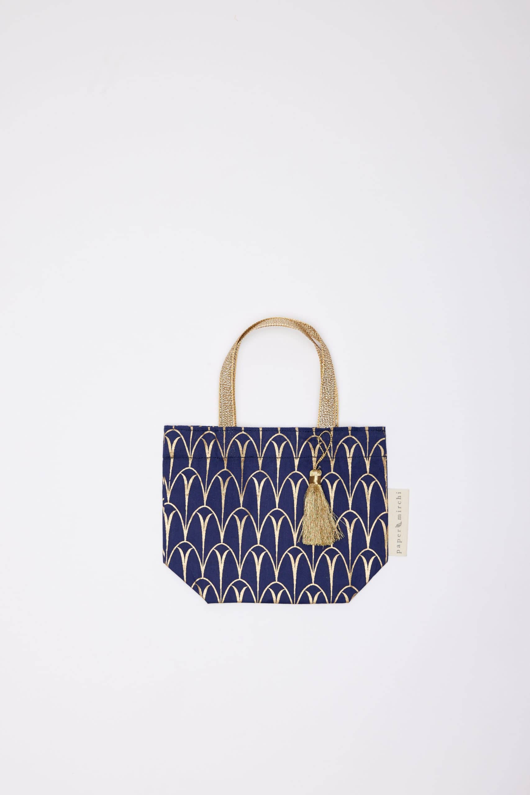 Elegant navy blue tote bag with gold geometric patterns and a tassel, perfect for stylish shopping and casual outings.
