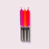 Bright pink and orange birthday candles with shiny silver holders, perfect for celebrations and cake decorations.