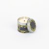 Fragrant white candle in decorative tin container with yellow floral design, ideal for home decor and gifting, available at The Wraperie.