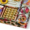 Gold decorative beads, floral themed jewelry storage box, vibrant floral jewelry display, colorful and artistic jewelry organization, with shiny gold beads and floral accessories.
