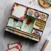 Colorful stationery and desk accessories in a floral-themed storage box, including paper clips, buttons, and decorative pushpins, perfect for organization and creative office spaces.