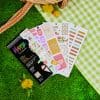 Brightly colored planner stickers from The Wraperie, perfect for decorating journals, planners, and scrapbooks with fun designs and motivational phrases. Ideal for organization and creative planning.