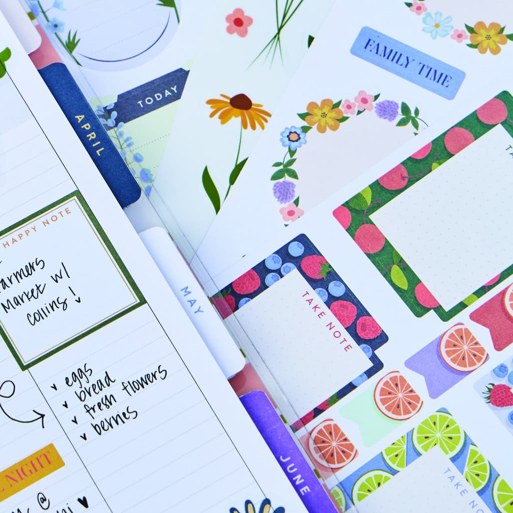 Feminine floral-themed stationery with colorful note cards, weekly planners, and refillable notebooks for personal organization and gift-giving at The Wraperie.