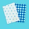 Bright blue and white patterned notebooks with motivational quotes, designed for organization and note-taking, ideal for students and professionals.