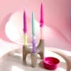 Colourful ceramic candle holder with twist design and pastel candles, modern home decor accessory for birthday or special occasions.