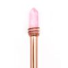 Pink quartz crystal wand wrapped with a rose gold metal band, used for healing and energy work. Perfect for meditation, chakra balancing, and crystal therapy practices.