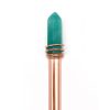 A gemstone wand with a turquoise crystal and a copper handle, used for healing and energy balancing.