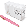 Pink pen with gold clip next to a clear plastic box labeled 