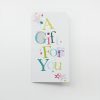 Bright, colorful gift card with "A Gift for You" message, featuring star and polka dot designs, perfect for celebrating special occasions at The Wraperie.