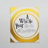 Golden foil-stamped greeting card with the message "A Whole Year more in CreditLier" from The Wraperie, ideal for celebrating milestones with personalized, luxurious stationery.