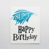 Blue and black "Happy Birthday" greeting card with a superhero-themed design featuring a star and comic-style lettering, ideal for birthday celebrations.