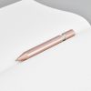 Elegant rose gold pen on grid paper, minimalist design, stationery accessories, stylish writing tool, professional desk accessory.