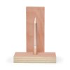 Minimalist rose gold pen on a wooden stand, stylish and elegant stationery accessory, ideal for writing, designing, or gifting, from The Wraperie collection.