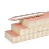 Sleek rose gold pen resting on stacked pastel-colored wooden blocks, minimalistic desk accessory, modern stationery, elegant writing tool with 