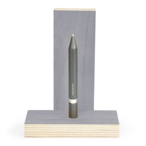 Sustainable gray pen displayed on a wooden stand, eco-friendly stationery product for note-taking and writing. Perfect for environmentally conscious office supplies or creative projects.