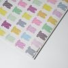 Colorful wrapping paper with playful puppy silhouettes featuring various polka dot and striped patterns, perfect for gift wrapping and creative crafts.
