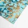 Vibrant metallic gold and blue marbled wrapping paper with an abstract, artistic pattern perfect for unique gift presentations and stylish occasions.