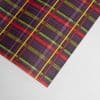 Vibrant tartan plaid wrapping paper with red, green, yellow, and purple stripes for custom gift wrapping, craft projects, and decorative purposes.