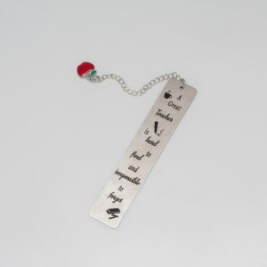 A metal bookmark with a humorous quote about teachers and a red apple charm, perfect for educators and students.