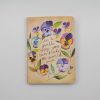 Colorful floral notebook with inspiring quote about kindness and change.