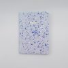 Vibrant blue and white splatter patterned notebook with "NOTES" printed in gold, perfect for organization and note-taking. Stylish stationery from The Wraperie, ideal for students and professionals.