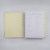 Checklist for wedding planning in a spiral-bound notebook at The Wraperie.