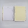 Aspirational planner with tabs for budget, recipes, decorations, attire, and grocery list, designed for organizing meal prep at The Wraperie. Perfect for tracking healthy wraps and meal plans.