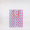 Colorful elephant patterned gift bag with orange handle, perfect for party favors and celebrations.