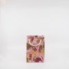 Pink and gold custom gift bag with stylish handles, ideal for gift wrapping at The Wraperie. Perfect for special occasions, parties, and celebrations, making your gift presentation elegant and memorable.
