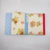 Bright floral and polka dot patterned gift wrap from The Wraperie, perfect for special occasions and gift packaging, featuring colorful roses and cheerful patterns.