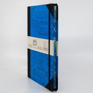 Colorful travel journal styled as a passport with passport stamps, ideal for documenting trips and adventures, designed by The Wraperie. Perfect travel accessories for journaling enthusiasts.