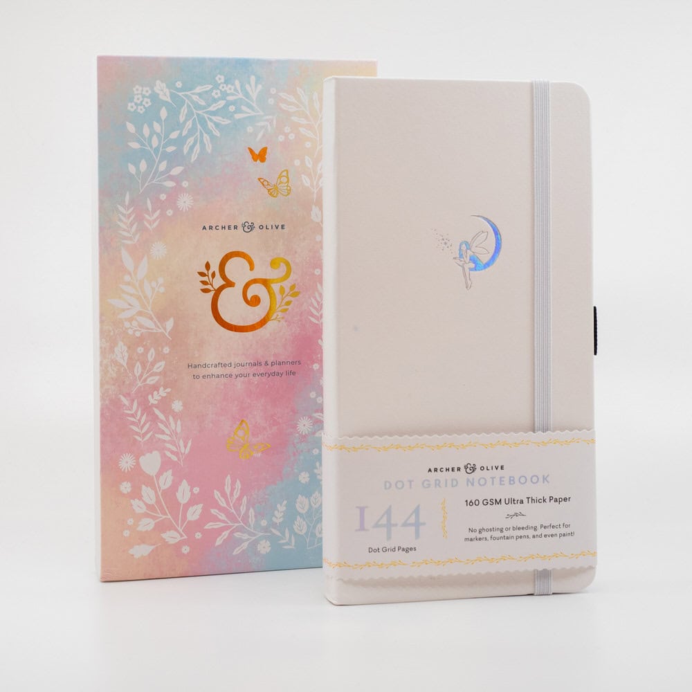 Soft pastel Archer & Olive dot grid notebook with fairy illustration and elastic closure, ideal for journaling, planning, and creative writing. Perfect for stationery lovers and organization enthusiasts.
