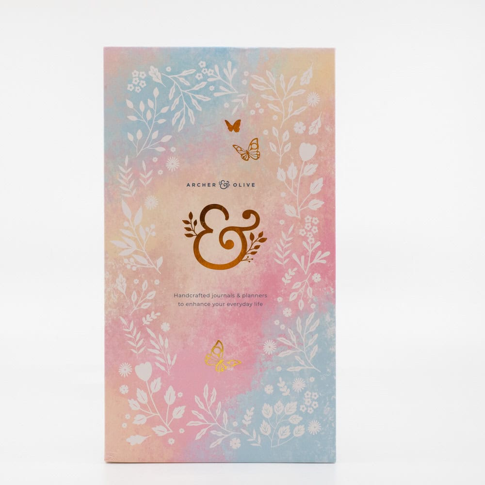 Handcrafted journals and planners from The Wraperie featuring floral and butterfly designs, perfect for enhancing your everyday life with stylish organization.