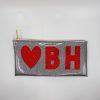 Glittery silver clutch bag with red heart and "BH" letters, perfect for personalized fashion accessories and stylish occasions.