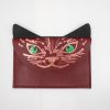 Vibrant cat-themed leather wallet with glowing green eyes, red and black color scheme, featuring detailed stitching and metallic accents, perfect for stylish animal lovers.