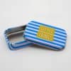 Colorful tin box with blue and white stripes and 