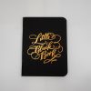 Handmade black notebook with gold calligraphy reading "Little Black Book," perfect for personal journaling, note-taking, or as a stylish gift item.