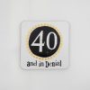 40 and in Denial sign, humorous road sign with black and white design and yellow stars, vintage style.