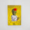 Bright yellow background with a cactus in a polka dot pot, featuring a red flower, showcasing modern desert-themed artwork at The Wraperie.