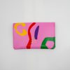 Vibrant pink designer clutch with colorful abstract print, perfect for fashion-forward accessories and statement styles.