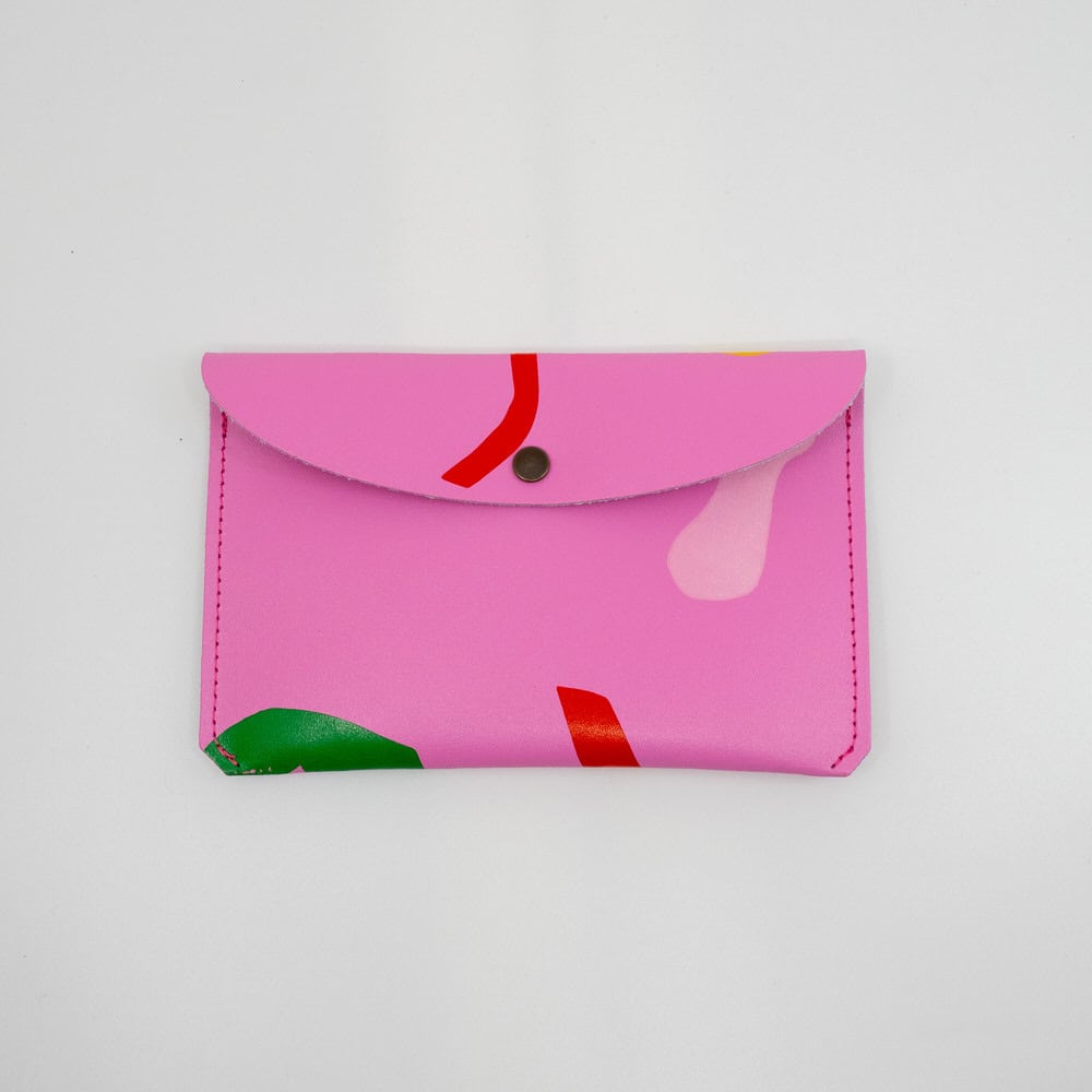 Vibrant pink food wrap wallet featuring abstract colorful patterns for eco-friendly, stylish, reusable food storage accessories. Perfect for snacks, sandwiches, and lunch on-the-go.