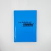 Bright blue notebook with bold black text saying "I am definitely not... TROUBLE" on a clean white background, showcasing fun and quirky stationery from The Wraperie.