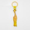 Bright yellow giraffe enamel keychain with pink spots, attached to a gold ring and yellow strap, designed for fun accessories and key organization.