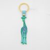 Bright enamel giraffe keychain with pastel blue strap and gold ring, featuring playful neon green and purple leopard print, perfect for home decor, accessories, or gift items at The Wraperie.