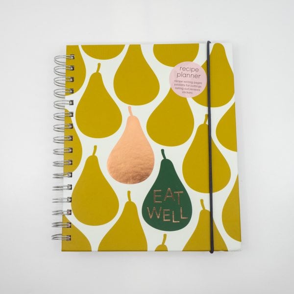 Vivid recipe planner notebook with fruit-inspired design, "Eat Well" message, and elastic band closure, perfect for meal planning, recipe notes, and kitchen organization.