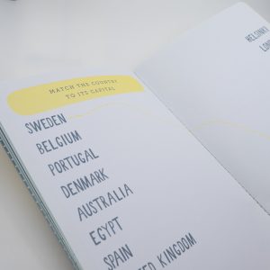 Colorful travel quiz book page with country names and matching game, showcasing fun educational activity for kids and adults.