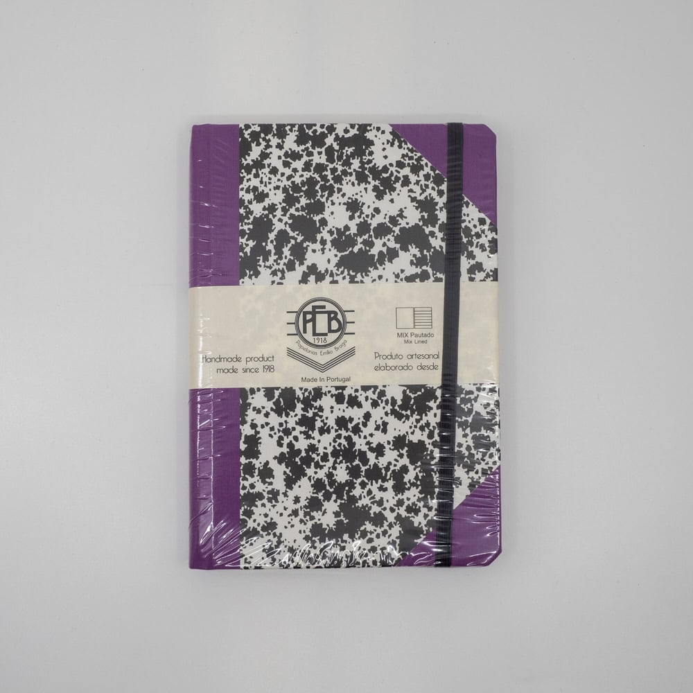 Colorful spiral bound notebook with black and white speckled cover and purple accents, ideal for school or office use.
