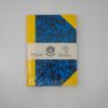 Colorful blue, yellow, and black patterned notebook by The Wraperie, a handmade product made since 1918, perfect for journaling or creative projects.