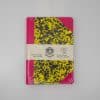 Colorful notebook with vibrant pink, yellow, and black abstract pattern, perfect for creative writing or note-taking. Unique handmade design from The Wraperie, established since 1918, emphasizing high-quality craftsmanship.