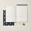 Premium weekly planner notebook with weekdays and checkboxes for organizational use, featuring a navy blue star-patterned cover, gold paper clips, and a pencil, ideal for personal or office planning.